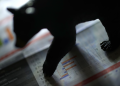 bear figurine standing on a financial report