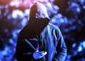 hacker looking into phone