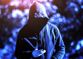 hacker looking into phone